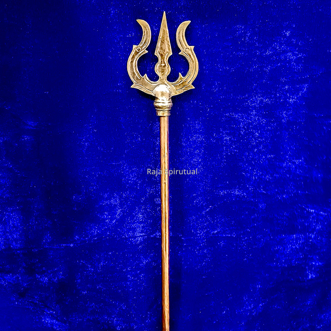 Copper pattai sulam trishul showing full length with copper handle and golden head on blue velvet background, straight front view