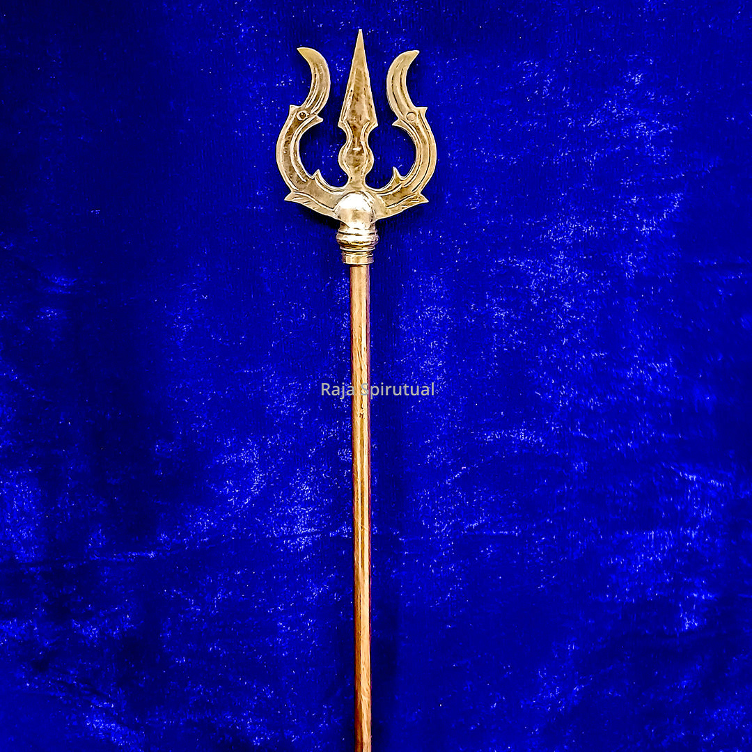 Copper pattai sulam trishul with narrow curved prongs and golden head on long copper handle on blue velvet background, straight front view
