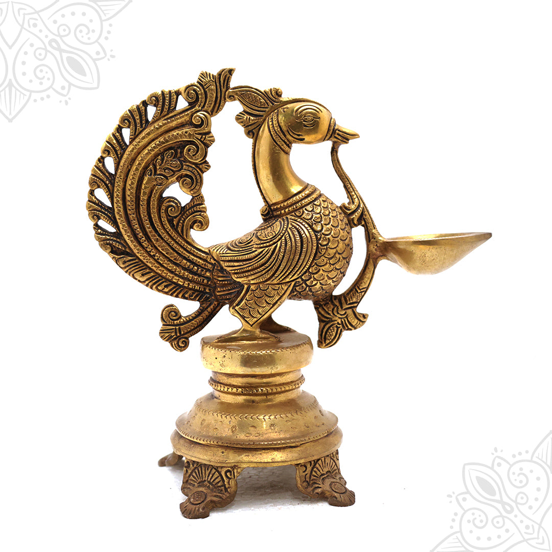 Fancy annam vilaku in a slight left side view with an open filigree tail fan holding an oil cup on a round footed base
