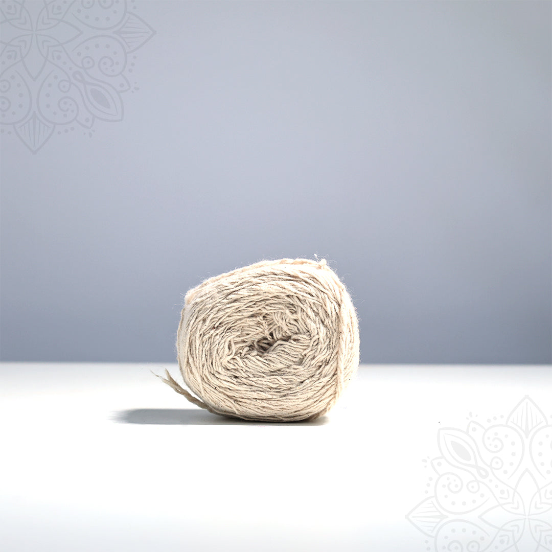 Kalasa nool straight front view with natural cream cotton thread roll on white surface used for sacred kalasam and pooja rituals