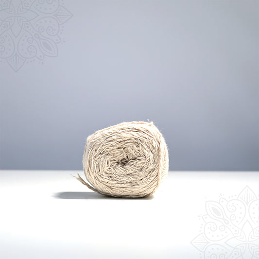 Kalasa nool straight front view with natural cream cotton thread roll on white surface used for sacred kalasam and pooja rituals