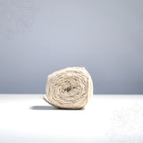 Kalasa nool straight front view with natural cream cotton thread roll on white surface used for sacred kalasam and pooja rituals