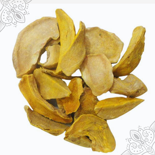 Dried kasthuri manjal kizhangu slices in golden yellow color shown in top-down view against white backdrop with mandala design.