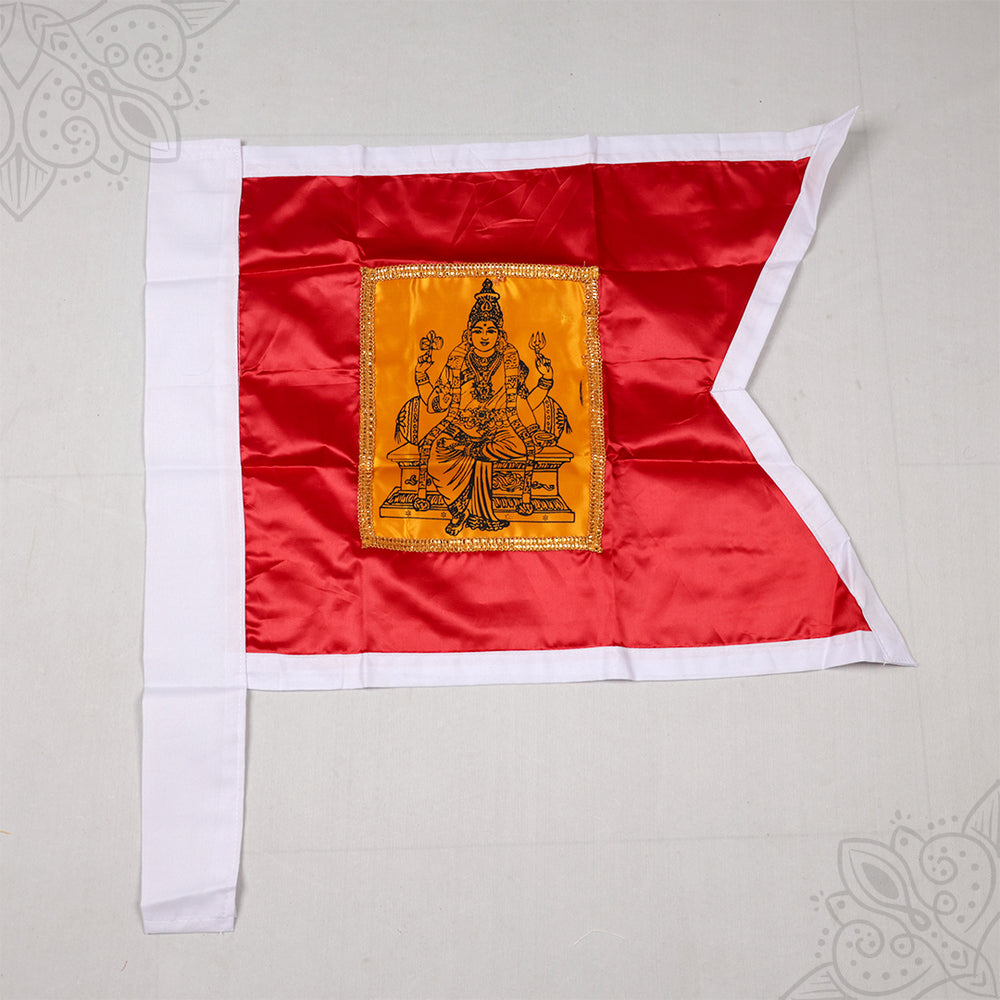 Kodi Amman red flag with seated Amman printed on golden patch and white border, top-down flat lay view on grey surface