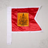 Kodi Amman red flag with seated Amman printed on golden patch and white border, top-down flat lay view on grey surface