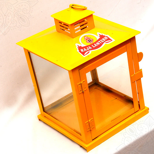 Large yellow lantern PC agal deepam in a top-down angle view showing Raja Lantern sticker on flat top panel and open glass door revealing interior tray
