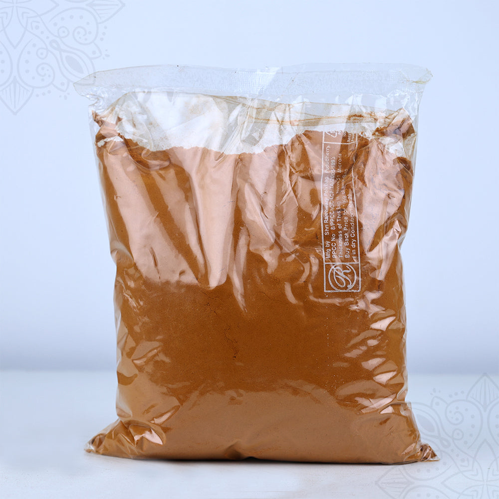Manjal powder 500g in a clear plastic packet with printed label shown in straight front view against a light blue backdrop.