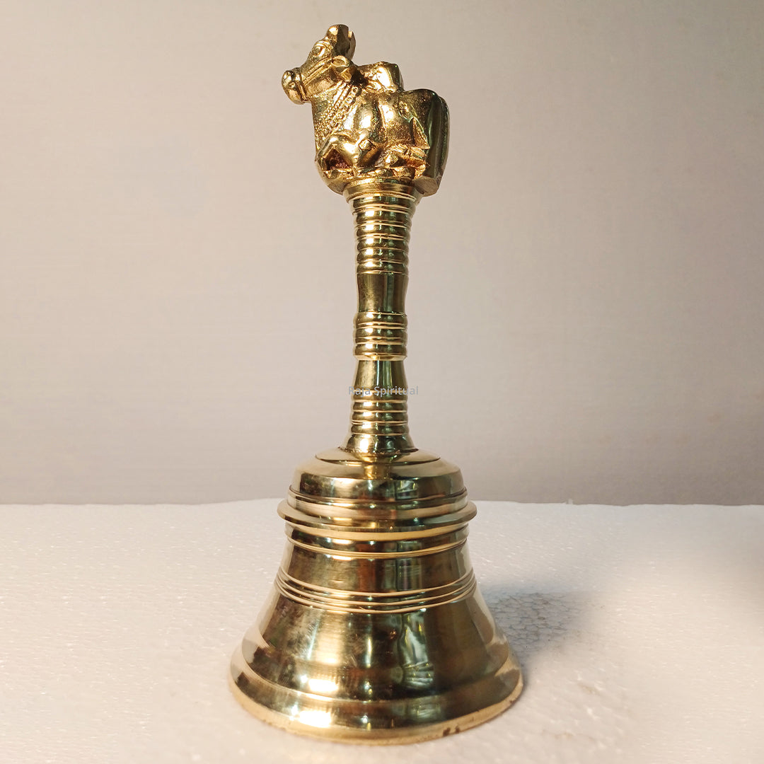 Nandhi bell front facing view sitting bull figure smooth handle bell base plain surface