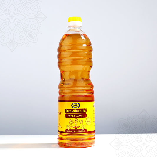 Om Shanthi Pure Puja Oil 500ml bottle with golden oil and yellow red label