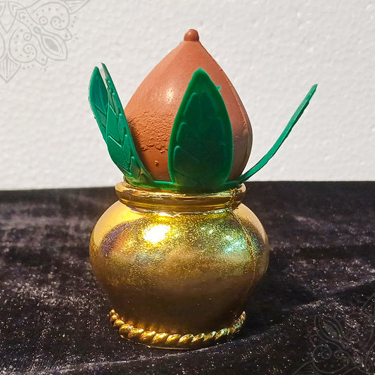 Plastic Kalasam with green leaf decorations and a coconut shown in a straight front view for pooja rituals.