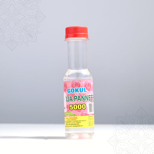 Gokul rosa panneer rose water bottle in a front-facing view showing pink rose label with red cap against a grey background