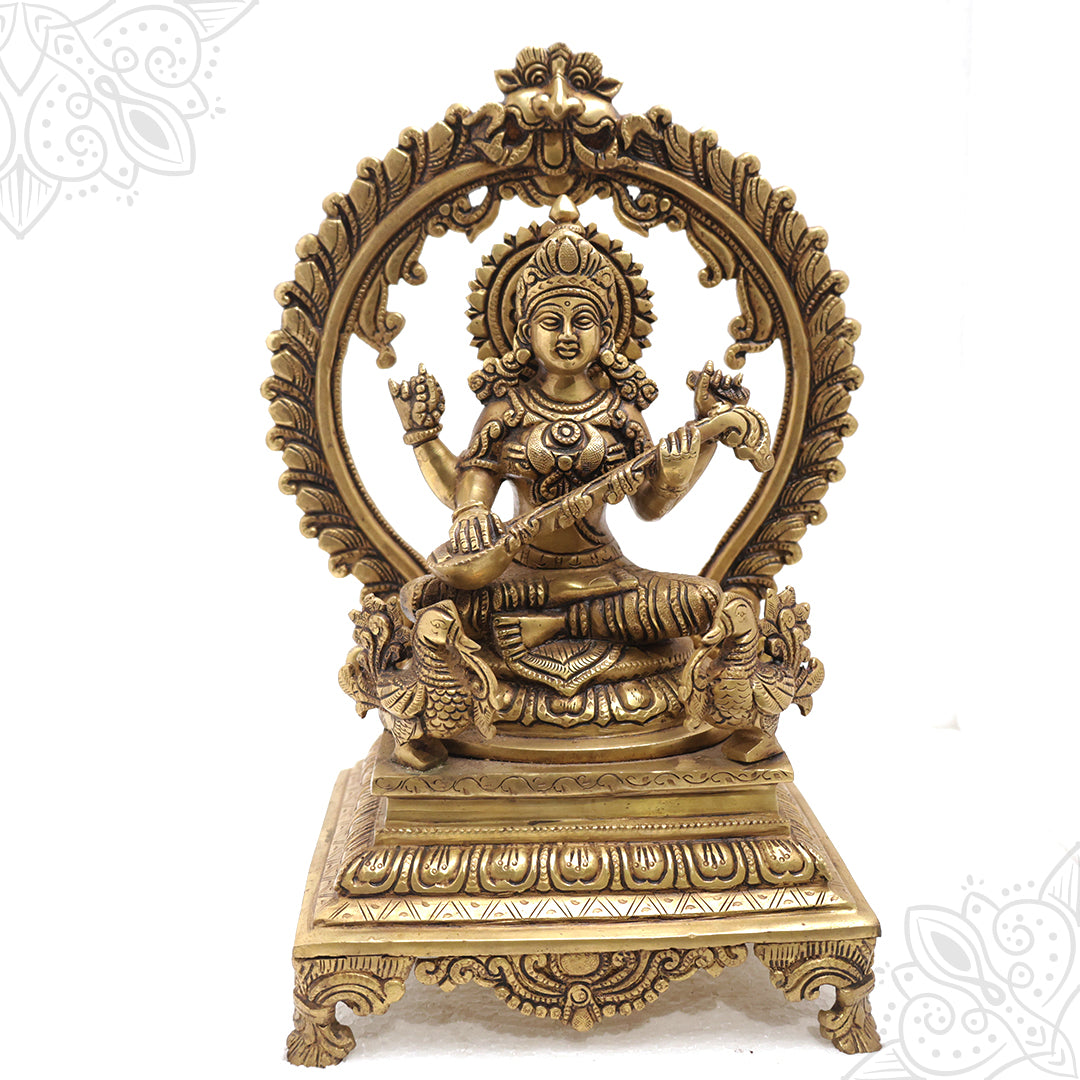 Saraswathy 13.5inch idol with peacock motifs on carved arch and footed base straight front view