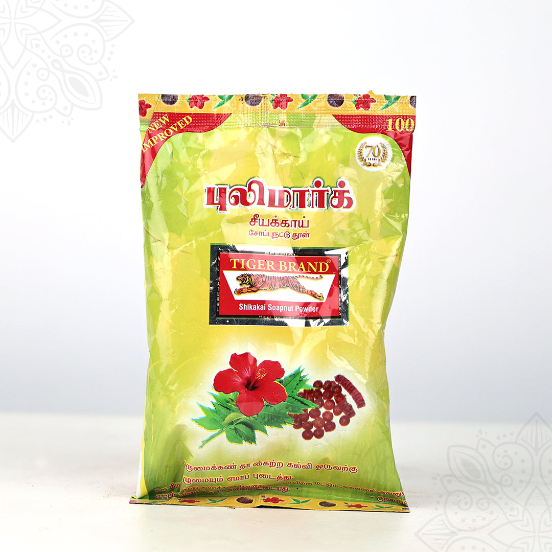 Tiger Brand shikakai soapnut powder green pack with hibiscus image shown in straight front view against white backdrop.