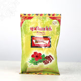 Tiger Brand shikakai soapnut powder green pack with hibiscus image shown in straight front view against white backdrop.