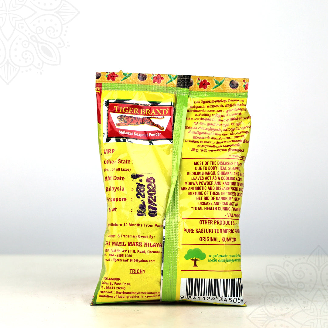 Tiger Brand shikakai soapnut powder green pack showing back label with ingredients and barcode in straight front view against white backdrop.