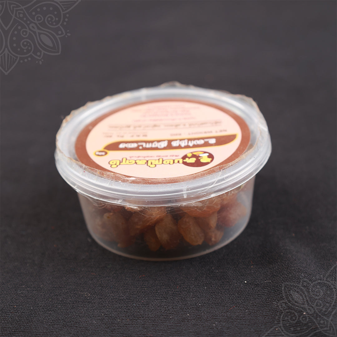 Subamangalam dry grapes pack slight top angle view showing raisins inside clear container