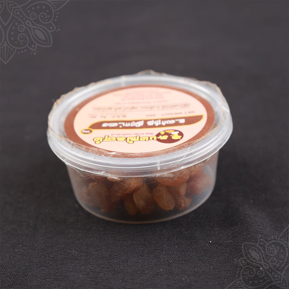 Subamangalam dry grapes pack slight top angle view showing raisins inside clear container