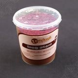 Subamangalam meroon kumkum bigger tub slight right angle view showing bright pink powder inside