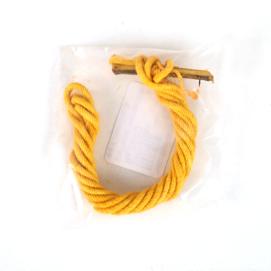 Handmade thali saradu single line yellow twisted rope with a wooden stick packed in a clear cover in a flat lay top-down view against a white background