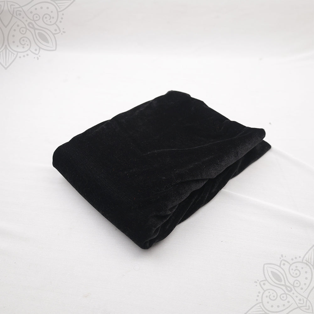 Black velvet cloth 1 meter folded neatly on white background top angle view for pooja decoration