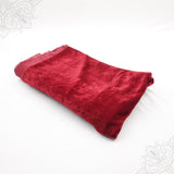 Dark red velvet cloth 1 meter folded neatly on white background top angle view for pooja decoration