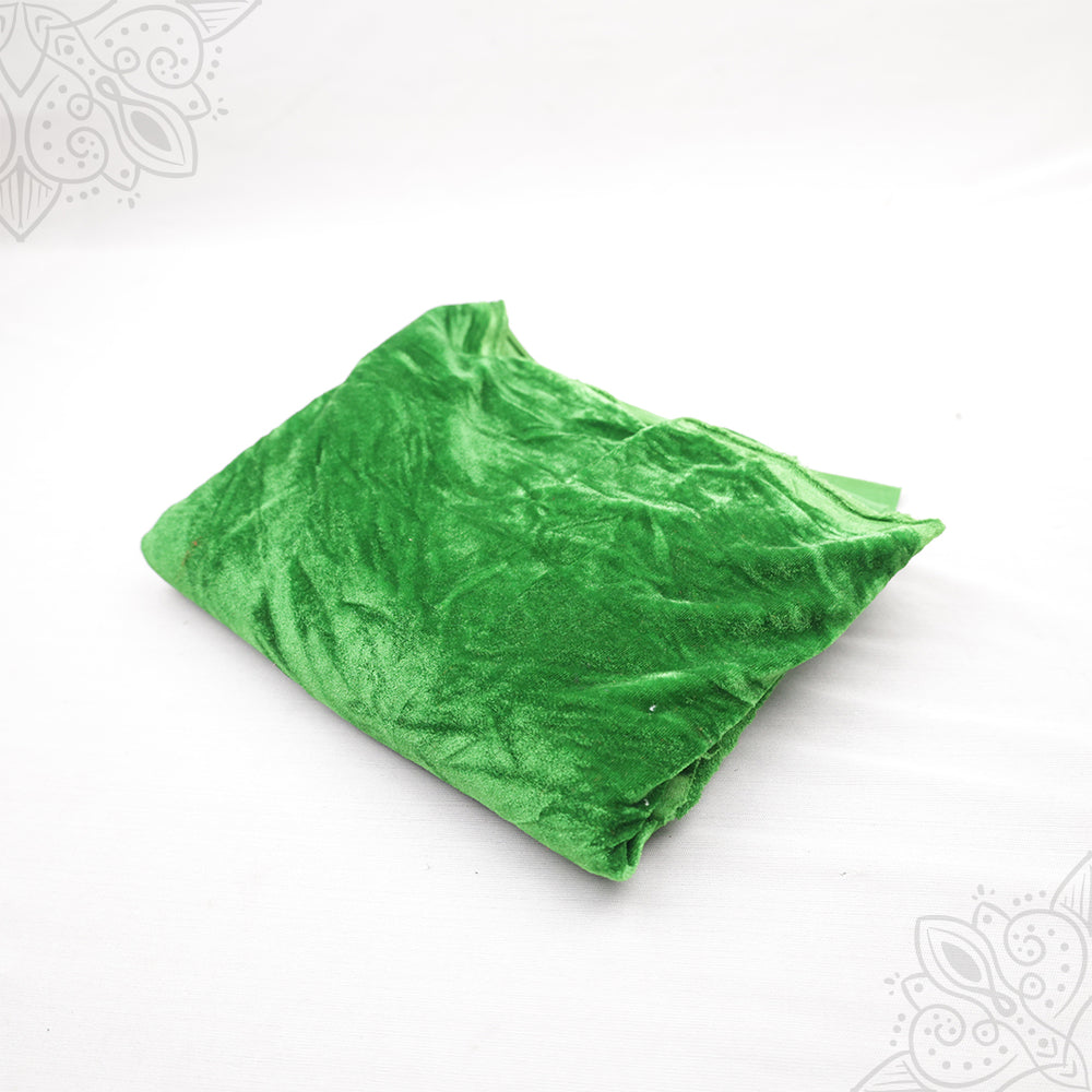 Green velvet cloth 1 meter folded neatly on white background top angle view for pooja decoration