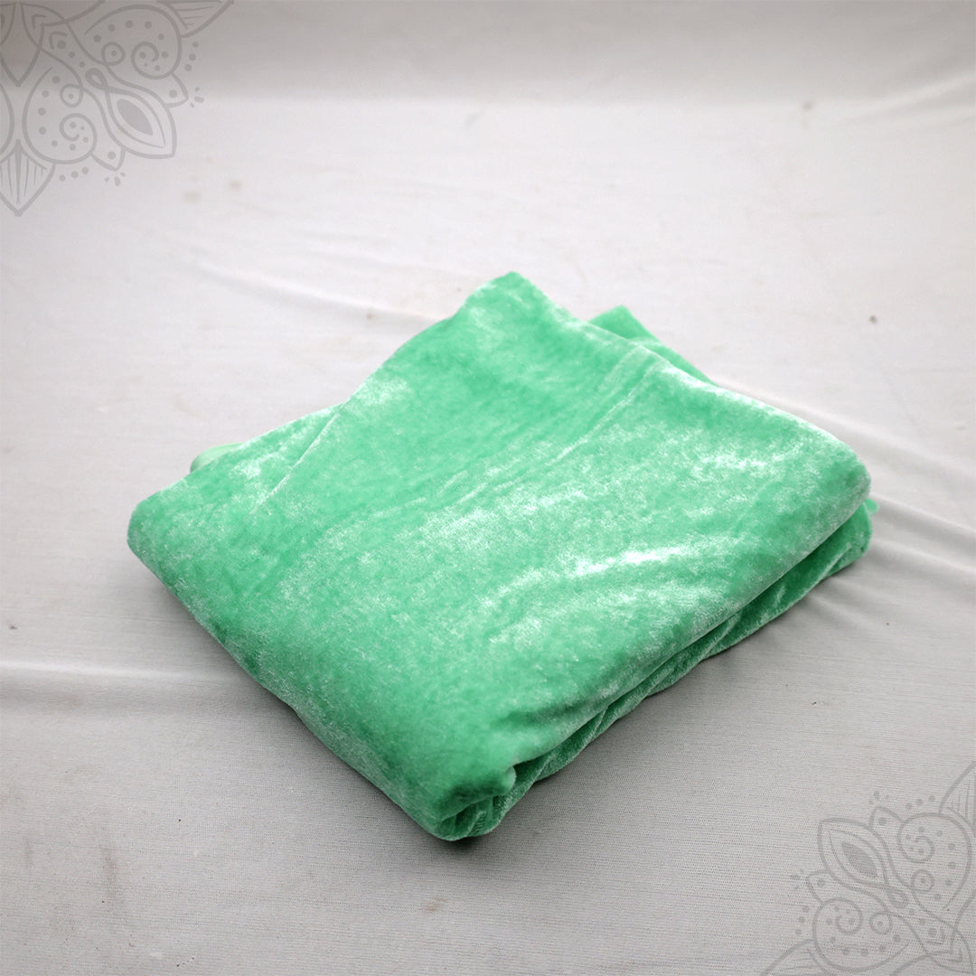 Light green velvet cloth 1 meter folded neatly on white background straight top angle view for pooja decoration