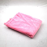 Pink velvet cloth 1 meter folded neatly on white background top angle view for pooja decoration