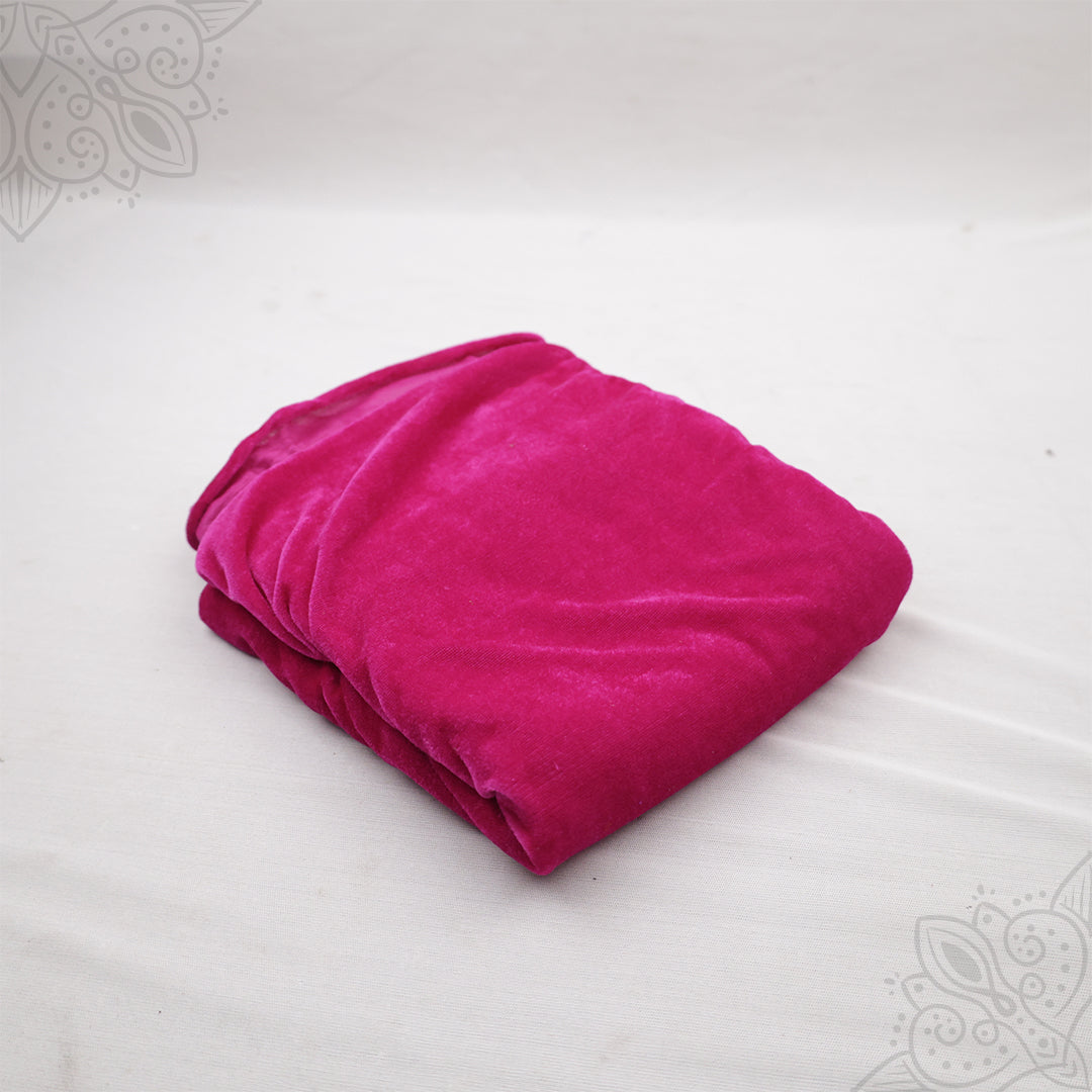 Rose pink velvet cloth 1 meter folded neatly on white background top angle view for pooja decoration