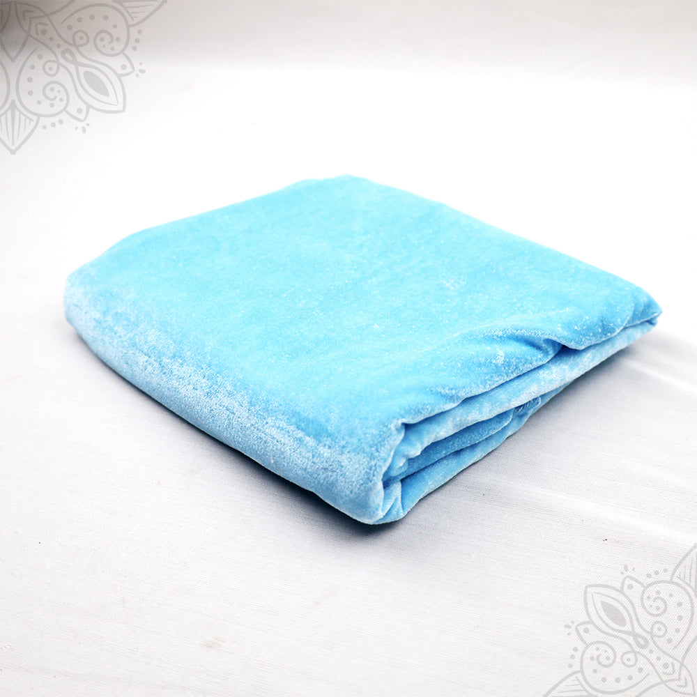 Sky blue velvet cloth 1 meter folded neatly on white background top angle view for pooja decoration