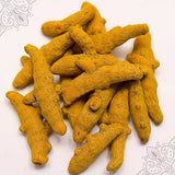Virali manjal kizhangu whole turmeric fingers piled loose on a white surface showing natural texture, slight top-down view